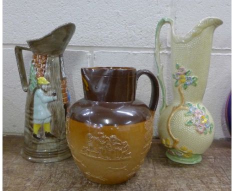 An E. Radford jug, a Crown Devon jug and a Doulton Lambeth saltglaze relief moulded jug with hunting and drinking scenes