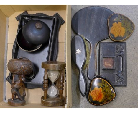 Ebonised items including a powder pot, brush, inkstand and a timer, African carving, etc.