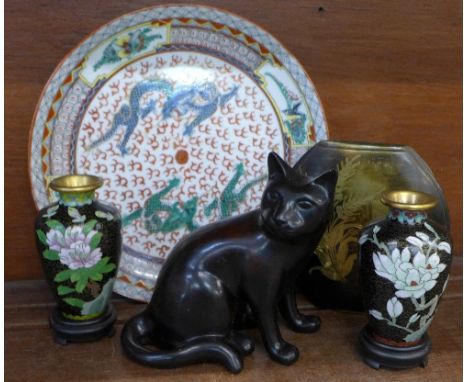 A pair of cloisonne vases on stands, an oriental plate, a bronze vase and a model of a cat