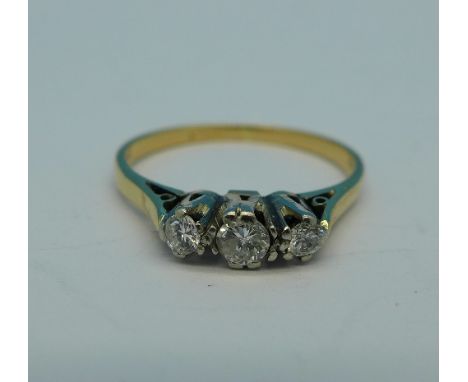 An 18ct gold and three stone diamond ring, 1.7g, K