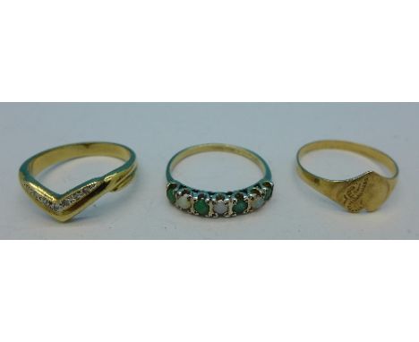 Two 9ct gold rings and a yellow metal ring set with opal and emeralds, 4.7g, all O