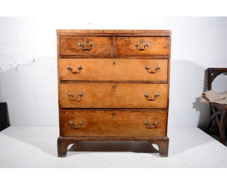 George III oak chest of drawers, rectangular top, two short and three long graduating drawers, brass bale handles, bracket fe