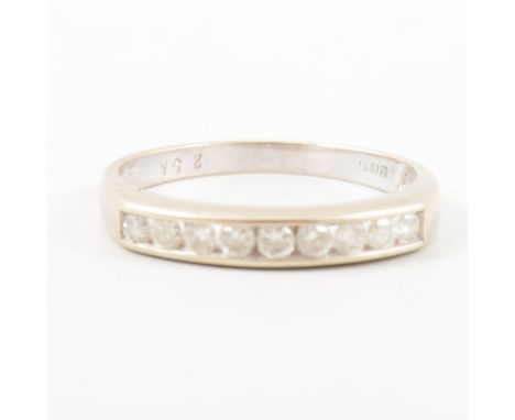 A diamond half eternity ring, nine brilliant cut diamonds channel set in a 9 carat white gold full eternity mount, 3mm wide a