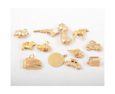 Twelve 9 carat yellow gold charms, animals, cigarette lighter, scooter, pistol etc, total weight approximately 20gms.