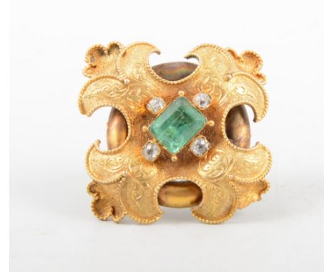 A brooch converted into a ring, a rectangular step cut emerald and four old cut diamonds set on a yellow metal brooch mount w