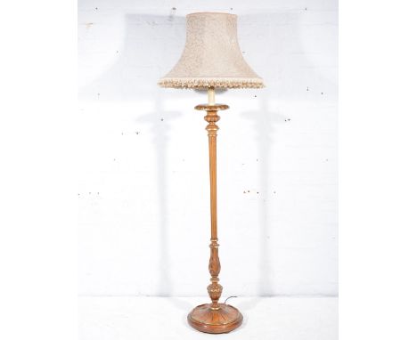 Walnut and parcel gilt standard lamp, with shade, 182cm overall.