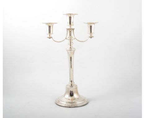A silver three light candelabrum, plain polished tapered column on a circular raised domed foot, filled base, 39cm high, hall