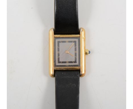 Must de Cartier - A silver-gilt tank watch, rectangular grey dial with black roman numeral chapter ring in a silver-gilt case