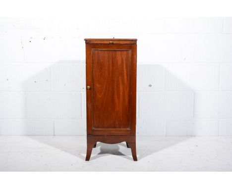 Edwardian mahogany pedestal cupboard, top with a moulded edge, slide above a panelled door, shaped apron, splayed bracket fee