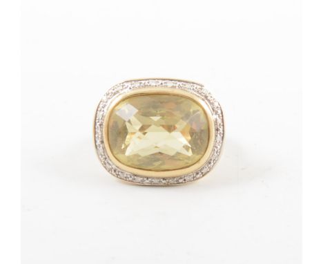 A large yellow quartz cluster ring, the multi faceted rectangular stone 14mm x 18mm, surrounded by small diamond points in a 