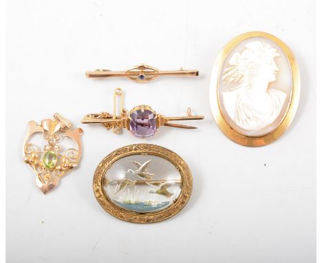 Four vintage brooches and a pendant, an oval carved cameo 40mm x 30mm, in a yellow metal mount marked 9ct, an amethyst bar br