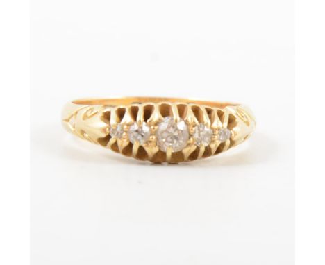 An Edwardian diamond five stone ring, the old brilliant cut stones claw set in an 18 carat all yellow gold half hoop mount, p