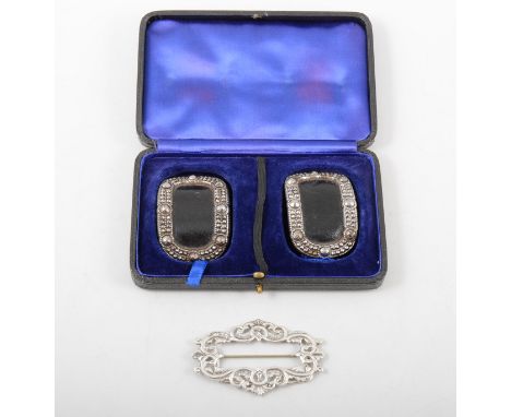 A pair of cut steel shoe buckles with leather inset in a fitted case, 60mm x 40mm, hinged clasp to back marked with initial R