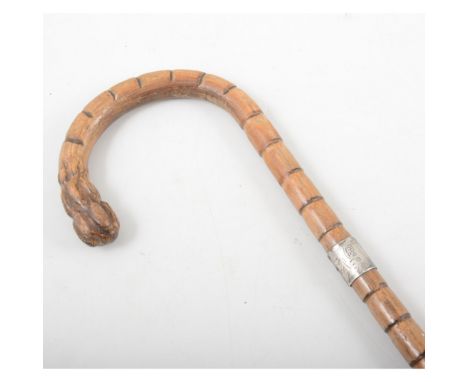 A silver mounted walking stick, the bamboo cane having a silver collar hallmarked London 1917, overall length 90cm.