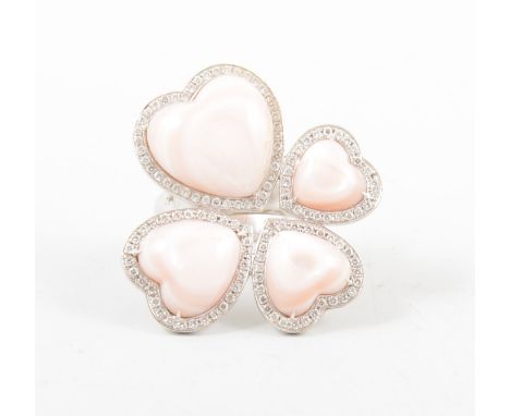 A large four heart dress ring, the pink mother-of-pearl hearts each surrounded by small brilliant cut diamonds, in an all whi