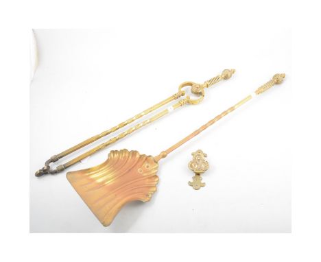 A brass fireside long handled shovel, tongs and small door knocker. (3)