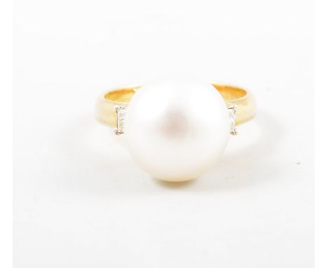 A cultured pearl dress ring, the 12.5mm button pearl peg set on a yellow metal mount marked 585 with a princess cut white sto