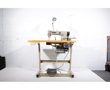 Brother Industrial sewing machine, fitted within a machinists table, (sold as a collector's item).