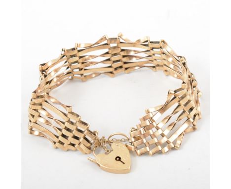 A 9 carat yellow gold bracelet, six bar gate link design, 15mm wide and fitted with a padlock fastener, approximate weight 12