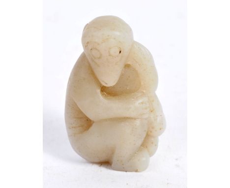 An 18th Century Chinese antique hand carved mutton fat white jade figurine carving depicting a monkey. Naive form and modelle