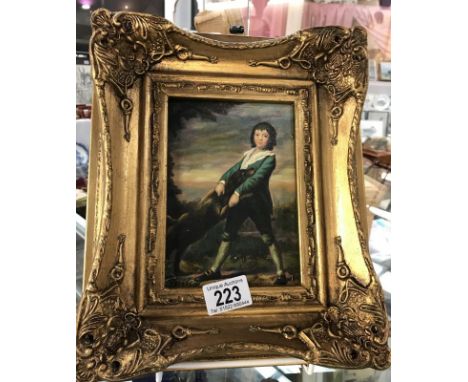 A gilt framed enhanced print of a child with a dog