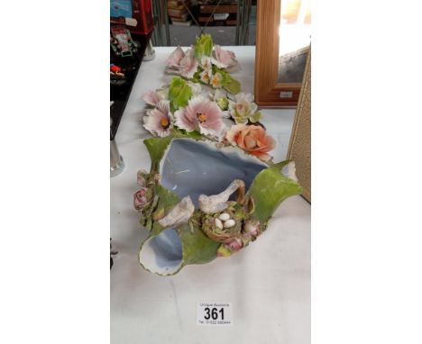 A quantity of vintage floral displays including a dish with crossed swords