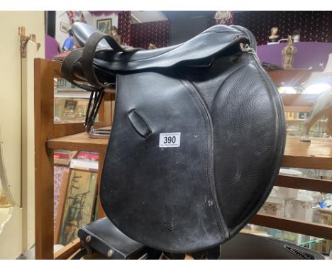 A Paul Jones 17" GP Saddle measured button to cantel, width unknown, includes stirrups and safety irons