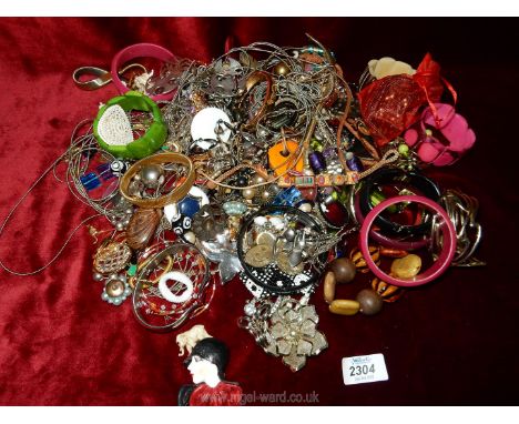 A large quantity of miscellaneous costume jewellery including bangles, vintage items, brooch in the form of 1920's lady, etc.