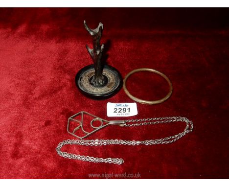 A Silver Bangle, Chester, maker C.H, necklace with large silver pendant, Birmingham 1983, maker EHM and a black ring tree wit