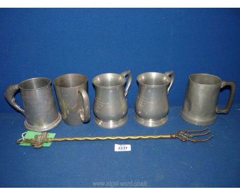 A quantity of pewter tankards and brass toasting fork.