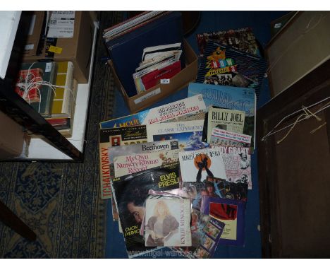 A quantity of LP's and 45 rpm's to include; Band Aid, H M Royal Marines, Elvis, Billy Joel, Kulie, etc.