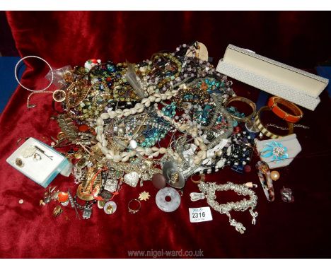 A large quantity of costume jewellery, vintage beads, bangles, etc.,