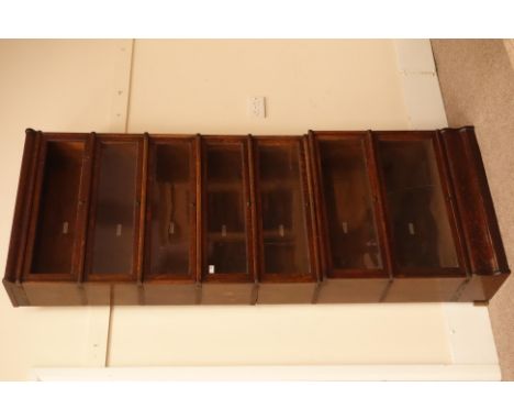 Early 20th century oak 'Globe Wernicke' seven tier library stacking bookcase, sliding hinged glazed doors on a roller pulley 