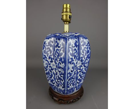 Porcelain Chinese blue and white table lamp on carved wood stand, H33cm    Condition Report   Click here for further images, 