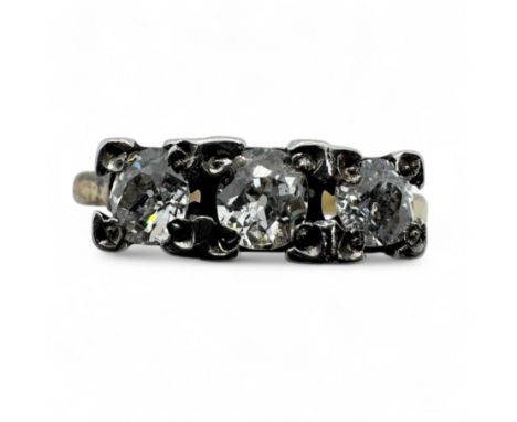 A diamond set trilogy ring.  Set with three old mine cut diamonds, the central stone measuring approximately 3.9mm x 3.5mm x 