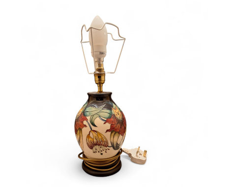 A tube lined Nicola Slaney "Anna Lily" lamp base by Moorcroft With cobalt blue and cream back ground. Base stands 23 cm tall 