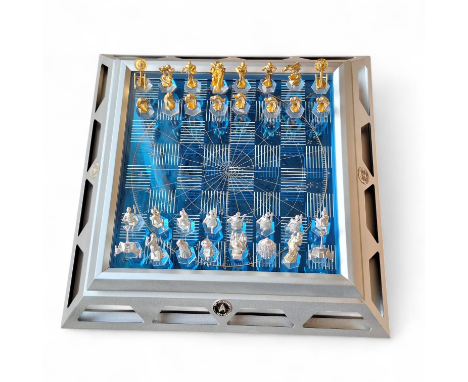 A fully boxed Franklin Mint 25th Anniversary Star Trek Chess Set.C1990's Individual pewter sculptured playing pieces plated i