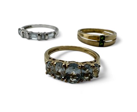 A trio of 9ct gold gem set dress rings. Comprising a 9ct gold gold ring with two tension set chrome diopside stones, size R; 