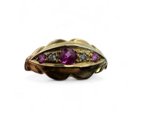 An 18ct gold Edwardian ruby and diamond ring. Featuring three round mixed cut rubies, interspersed with two old eight cut dia