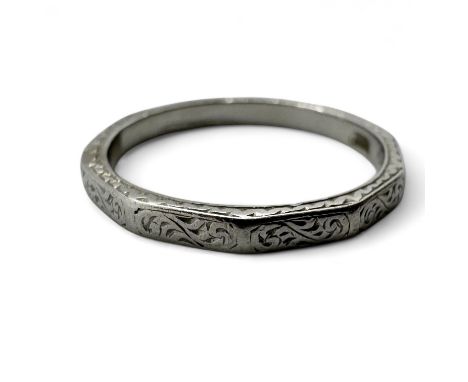 An Art Deco engraved band ring. With decahedral facets.  Size K. Approximate weight 2.86 grams. 