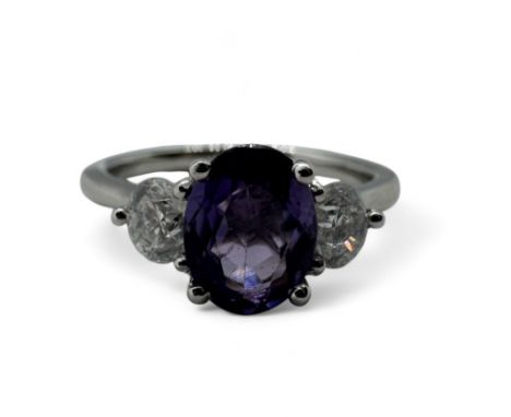 A platinum purple sapphire and diamond dress ring. Featuring an oval mixed cut violet-purple sapphire, of an estimated 1.30 c