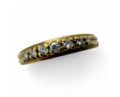 A diamond half eternity ring. Claw set with seven graduated round brilliant cut diamonds, to a central stone with a diameter 