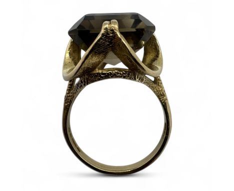 A Vintage smoky quartz cocktail ring substantial ornamental raised mount. Stone measuring approximately 18mm x 12mm face up. 