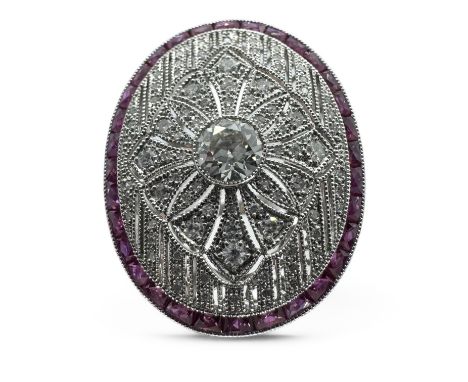 A large Art Deco style panel ring set with over 2 carats of diamonds ad accenting calibre cut rubies in an ornate mount. Feat
