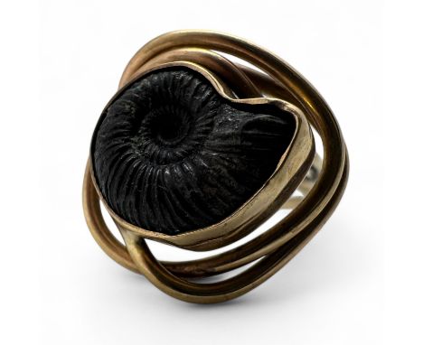 A 9ct gold ammonite fossil set hand made ring. Hallmarked for SA, Birmingham, undated. Size R. Gross weight approximately 7.9
