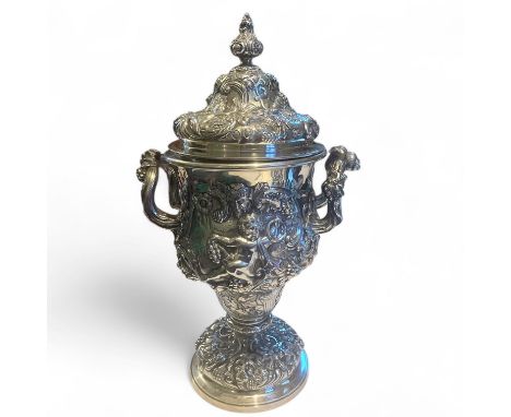 An Edward VII sterling silver lidded cup, marked for Brook & Son, Edinburgh.  With embossed decoration featuring Bacchus, put