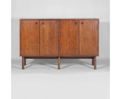 Pierre Jeanneret (Swiss, 1896-1967), a side cabinet, 1950s, teak, with two pairs of cupboard doors, each opening to reveal sh