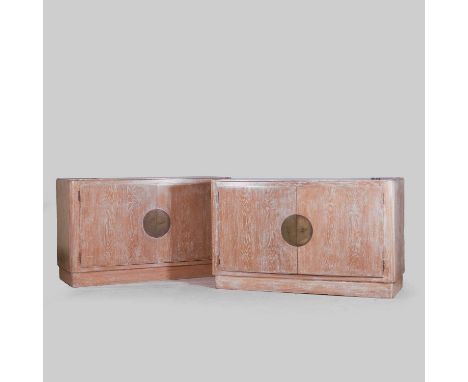 Jacques Adnet (French, 1900-1984), a pair of limed oak cabinets, each of quadrangular form with rounded uprights resting on a