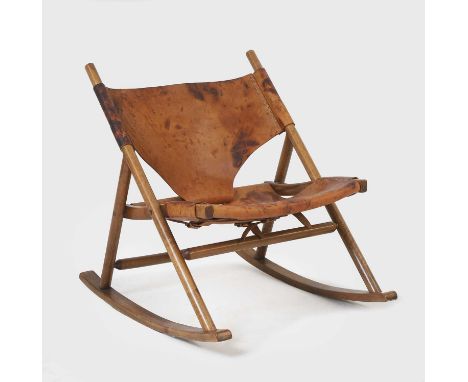 Danish, a rocking chair, c.1950s, teak and leather,62cm wide79cm deep73cm highCondition ReportThe rocking chair is structural