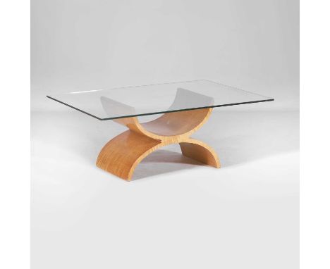 Tom Schneider, a coffee table, the cherrywood base supporting a rectangular glass top,107cm wide76cm deep42cm high